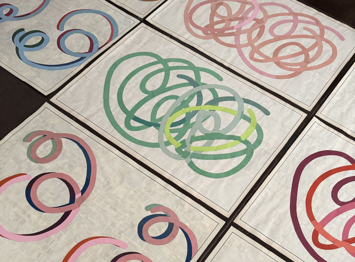 Abstract artwork featuring multiple colorful overlapping circular scribbles on a light textured background