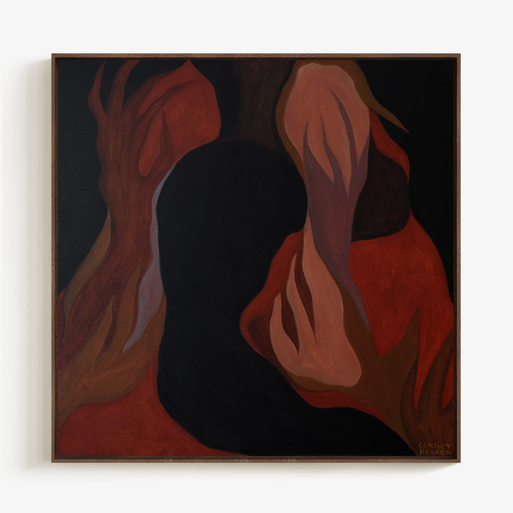 Framed abstract artwork with dark red and brown shapes displayed against a light background