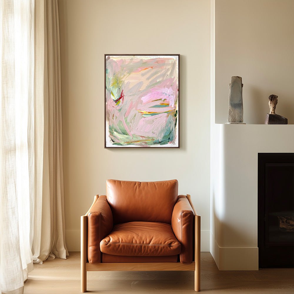 Interior view showing a framed abstract painting above a modern brown leather lounge chair in a bright living space