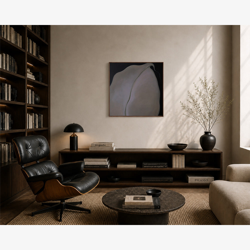 Abstract framed art piece hanging above a dark wooden sideboard in a modern moody living room interior