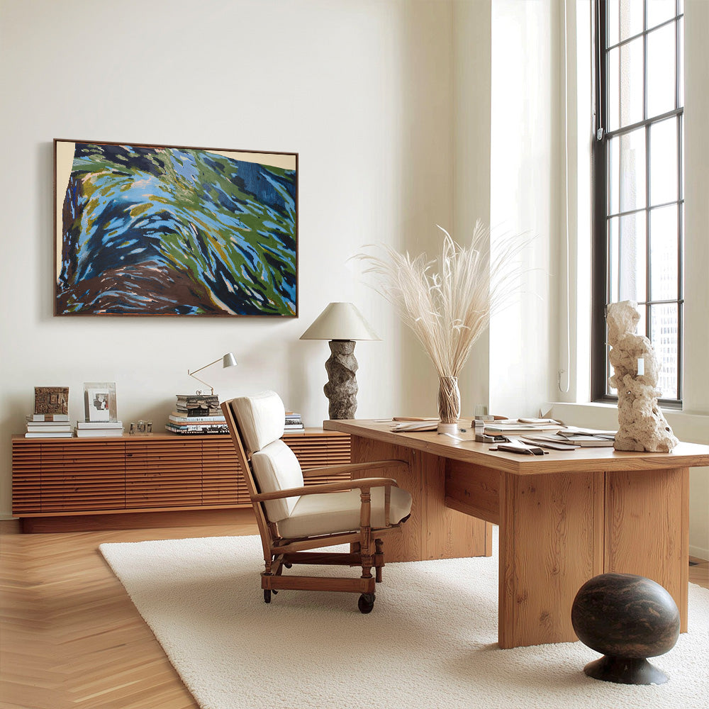 Modern office interior with an abstract painting hung above a long wooden credenza near a desk and an armchair
