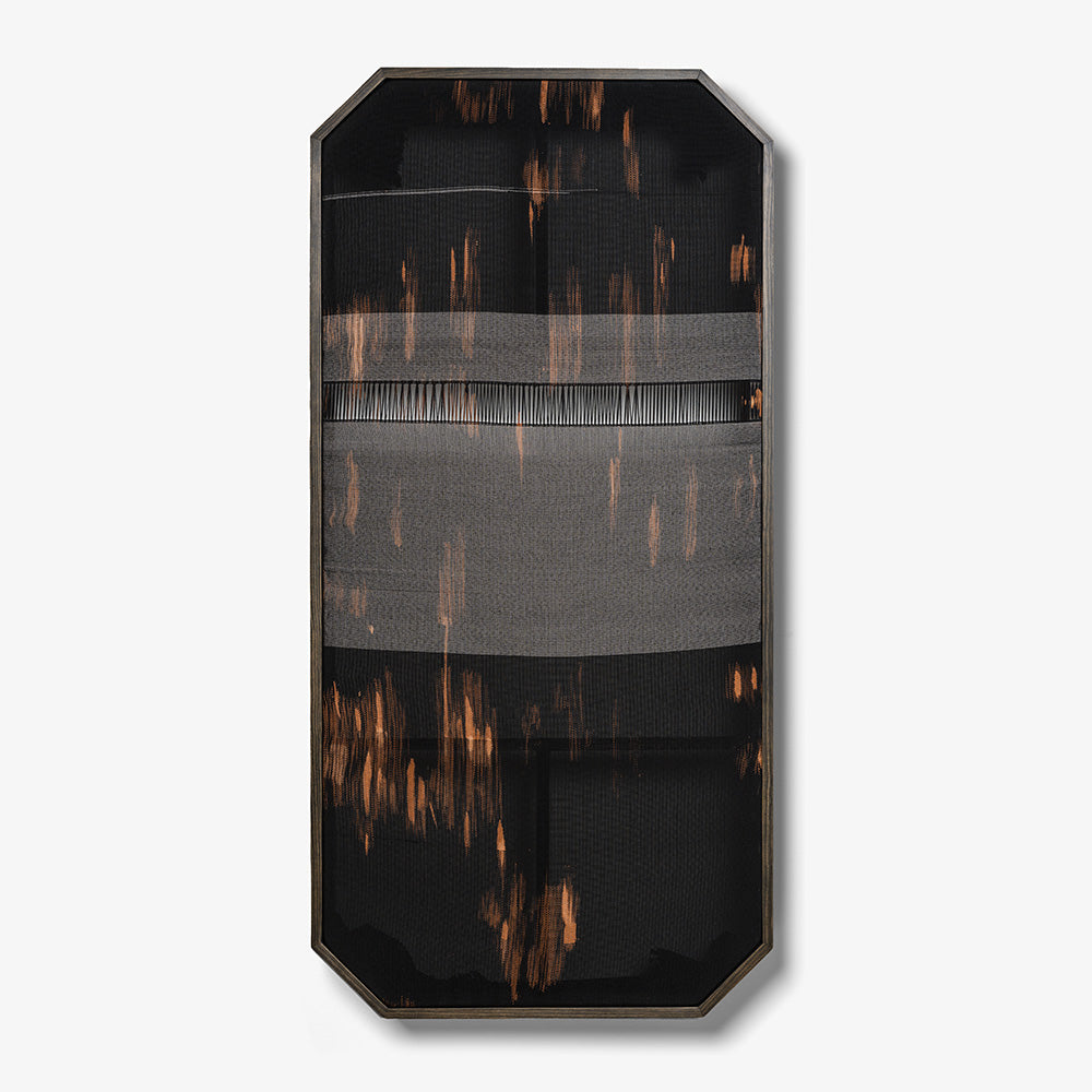 Tall octagonal wall-mounted textile with black and orange abstract streaks and a horizontal open-weave strip