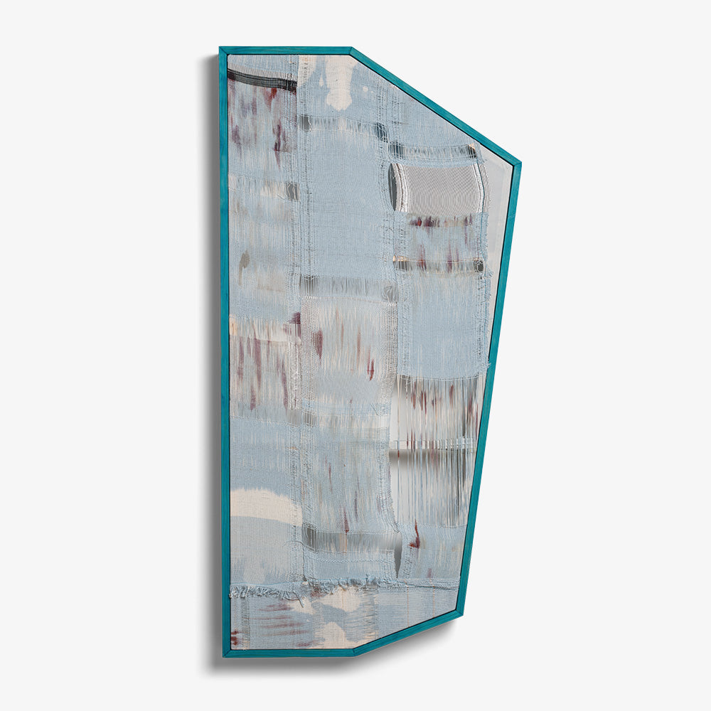 Light blue irregular-shaped textile art mounted in a custom teal frame