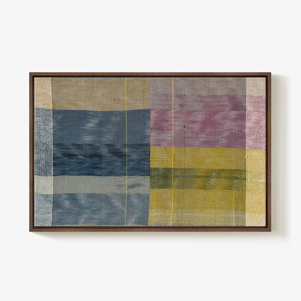 Textile art with a plaid pattern in blue yellow and purple mounted in a dark walnut wood frame