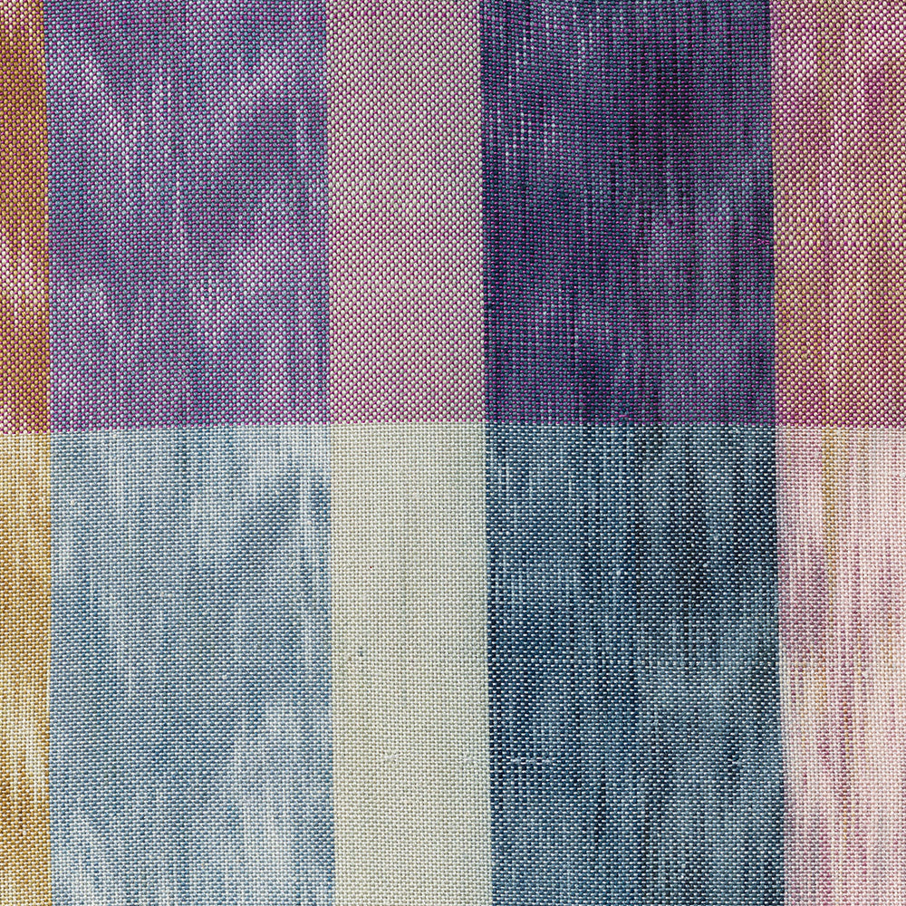 Close-up view of woven textile featuring intersecting vertical and horizontal stripes in purple blue and pink