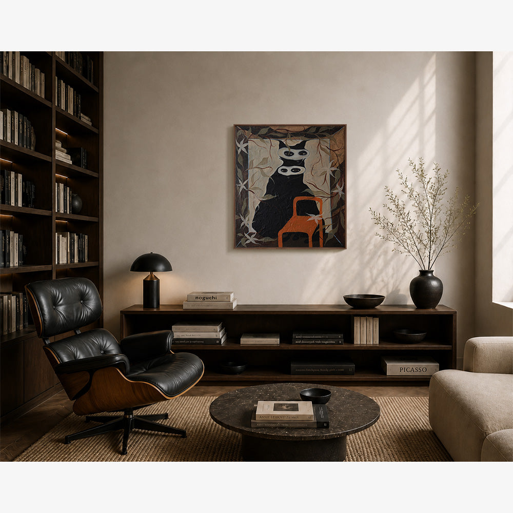 Contemporary living room with a framed painting of a black cat with two white masks hanging on a beige wall