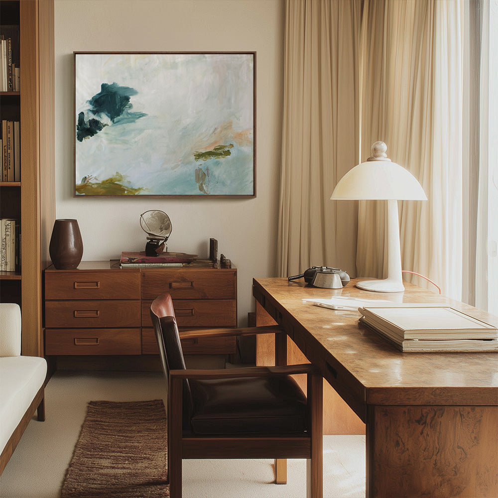 An office scene with an abstract painting titled Coastal Blues 03 hanging above a wooden credenza and a desk with a lamp