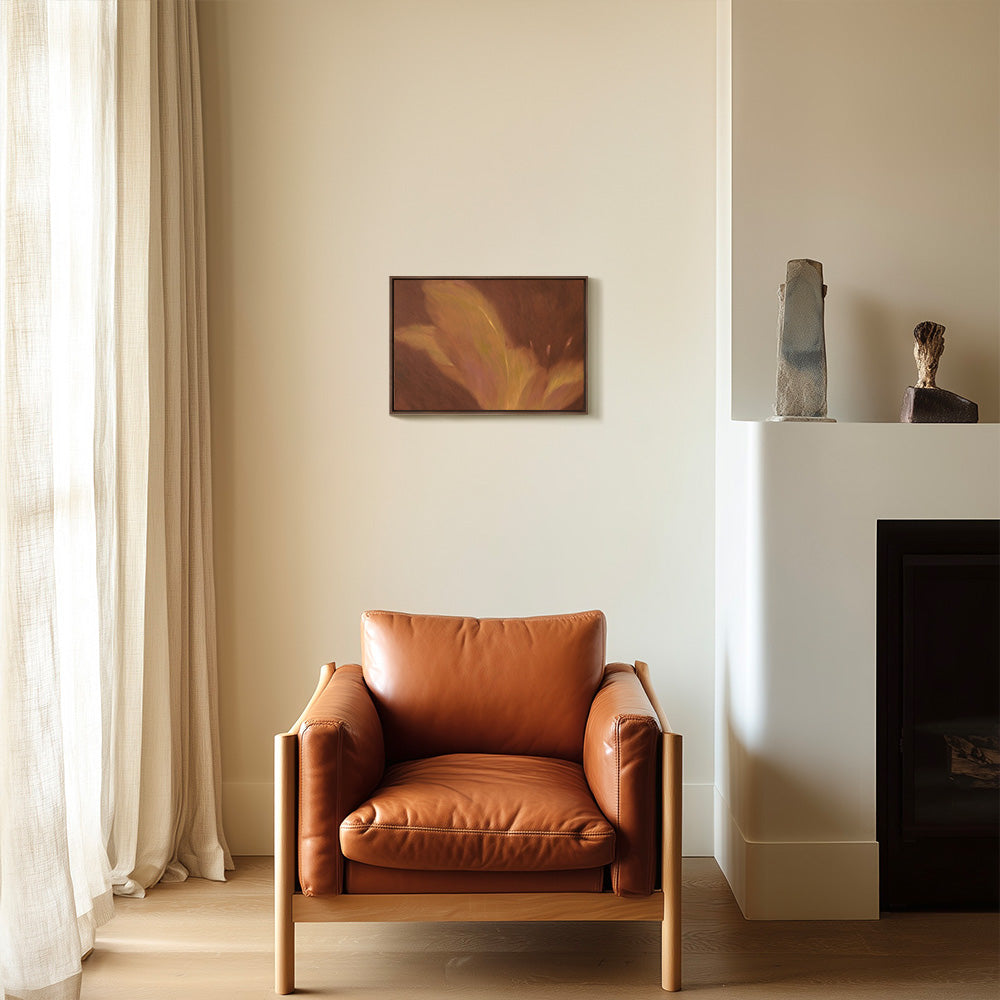Garnet Flow abstract painting with golden yellow and reddish-brown tones hanging above a leather armchair