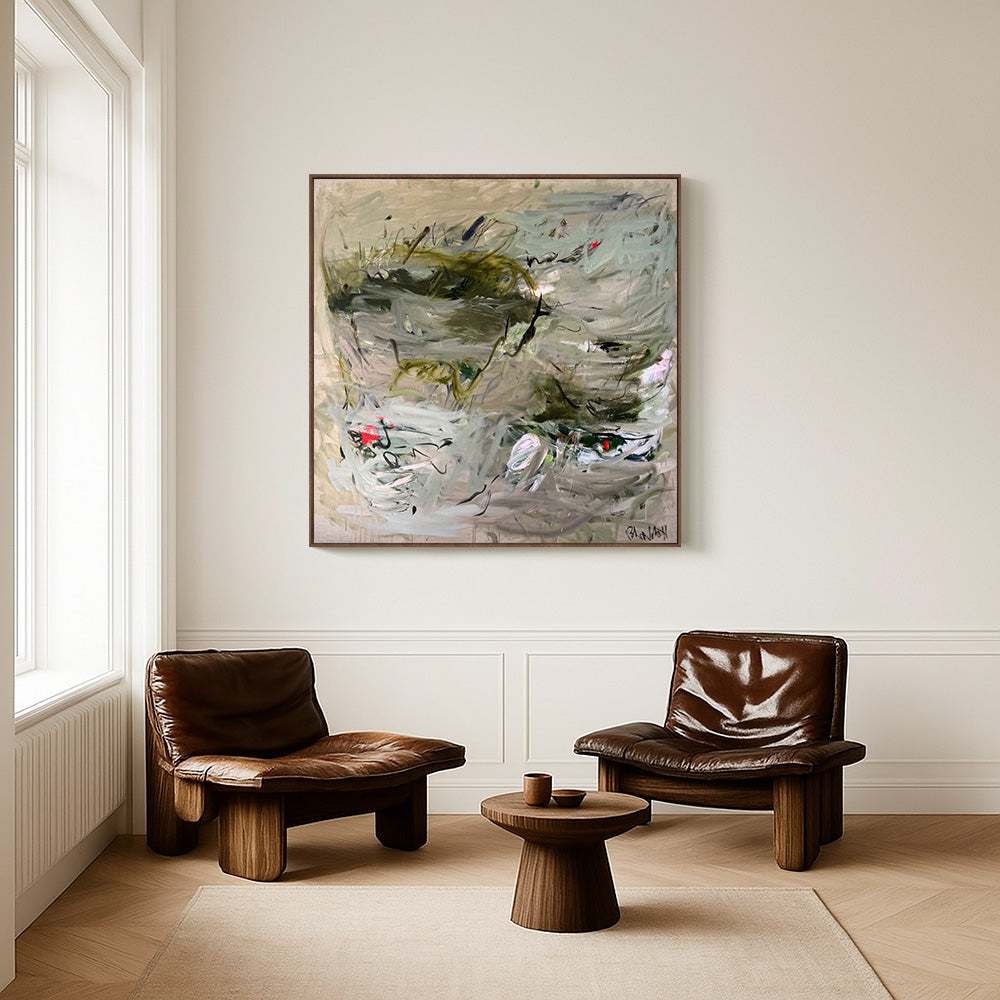 Square abstract painting hanging on a neutral wall between two brown leather lounge chairs in a minimalist room