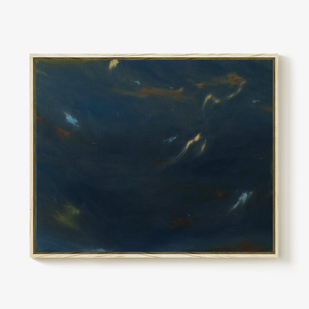 Framed horizontal painting in a light wood frame featuring abstract blue gold and green brushstrokes on dark navy