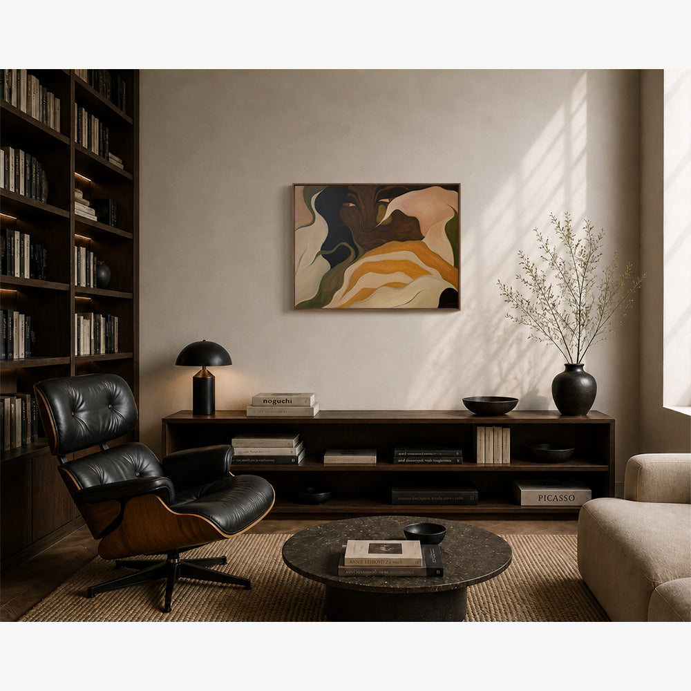 Interior room featuring a framed abstract painting above a dark wood console table and an Eames-style lounge chair
