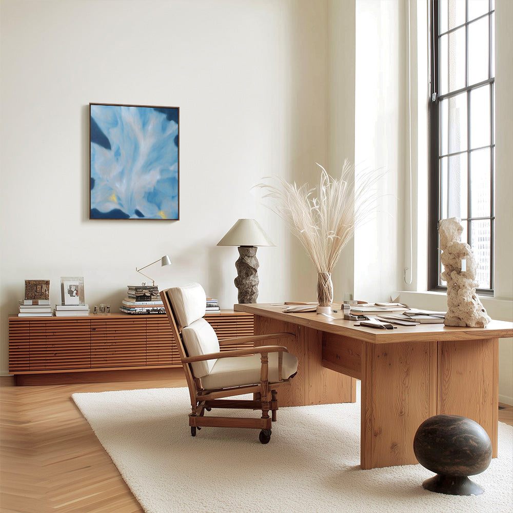 Interior room featuring a framed abstract blue painting by Jihyeon Park wood desk and leather chair on a rug