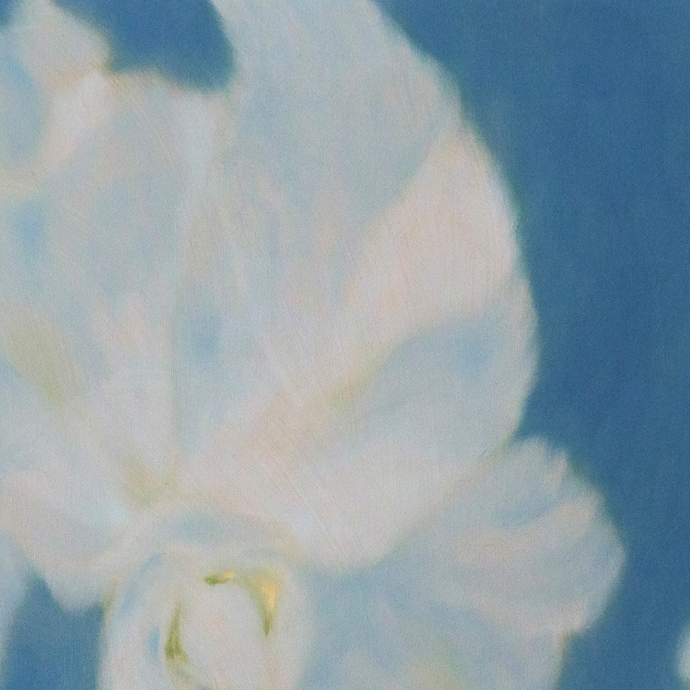 Close-up of the abstract painting Onde Profonde V showing white petals with yellow accents against a blue background