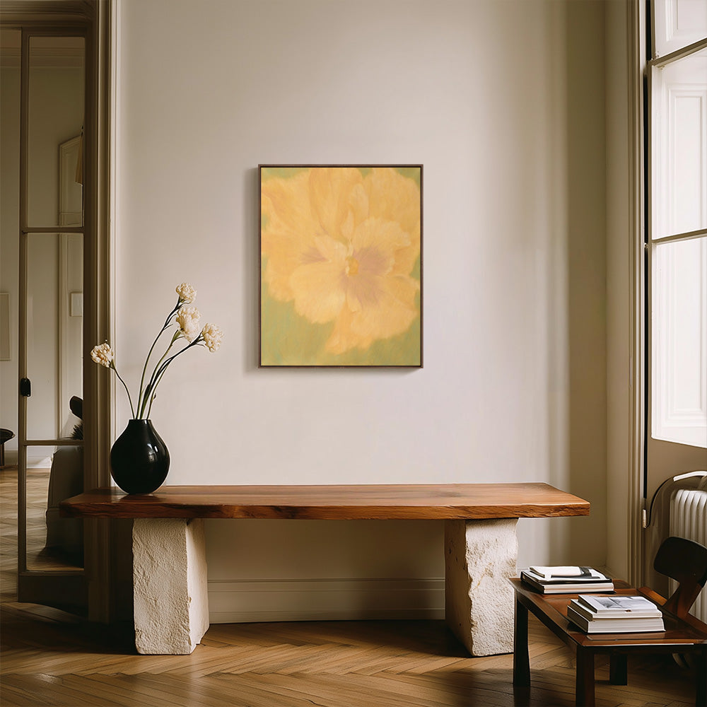 Abstract painting with a yellow flower on a green background hanging above a live-edge wooden bench in a stylish room
