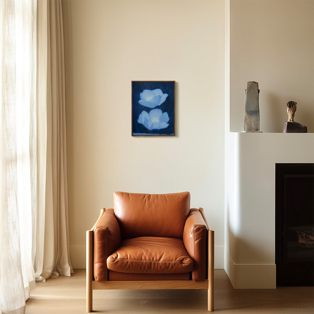 Still Life in Deep Blue painting with two light blue flowers on a dark blue background in a living room