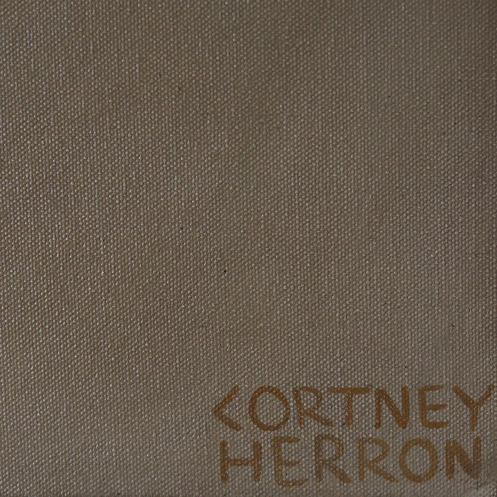 Close-up of canvas texture showing the artist signature Cortney Herron in gold paint