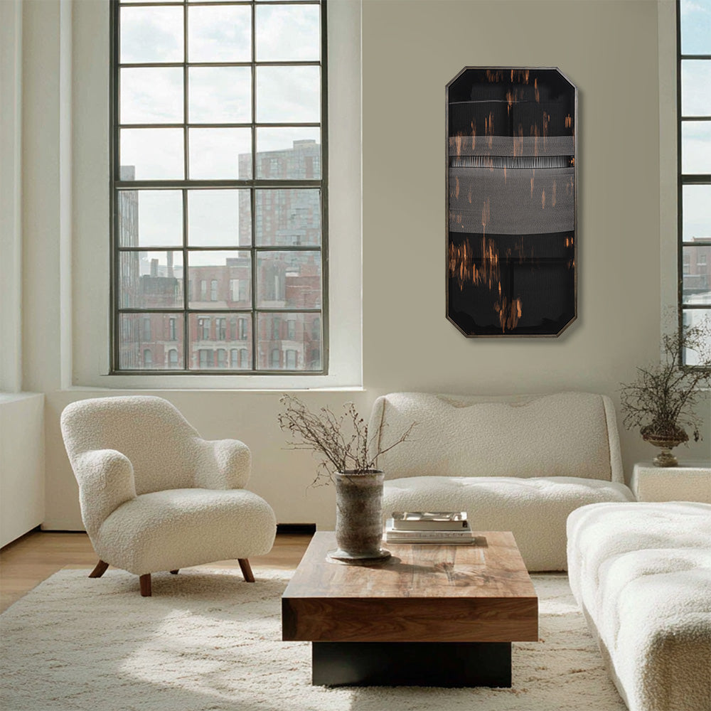 Octagonal black and orange textile art displayed in a modern living room setting