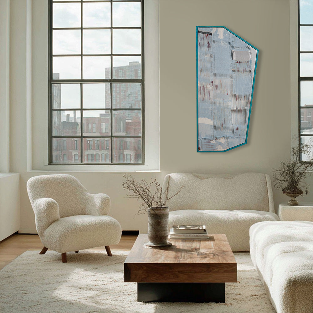 Irregularly shaped textile wall art with blue and grey abstract patterns in a contemporary living room