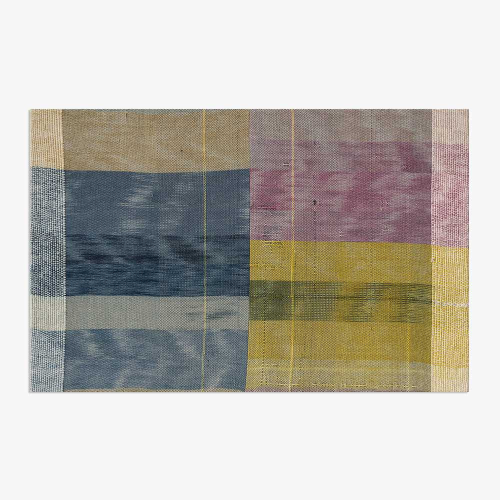 Unframed textile with a plaid pattern consisting of blocks of blue yellow and purple