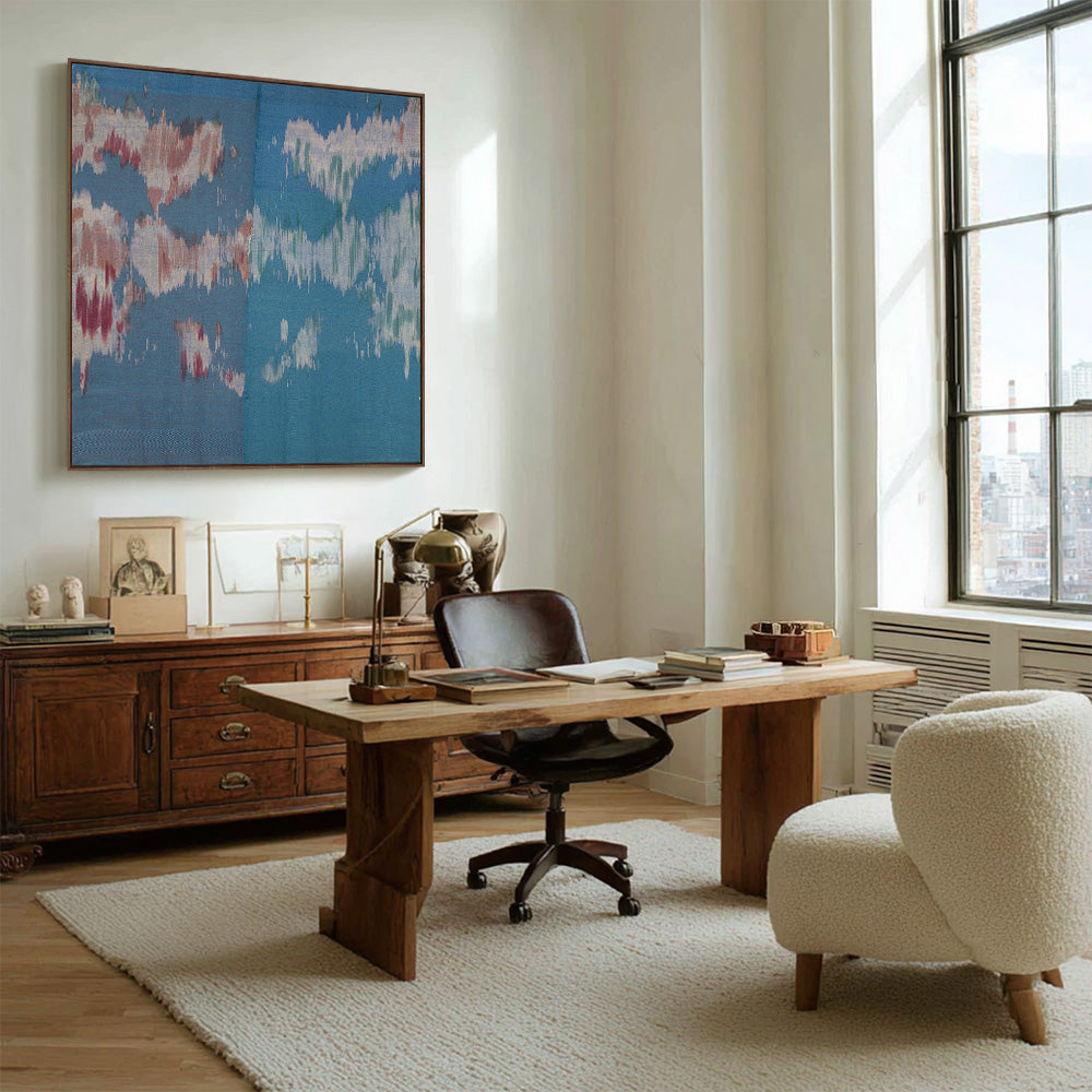 A modern home office featuring the Untitled 182 textile artwork hanging on a white wall above a wooden desk