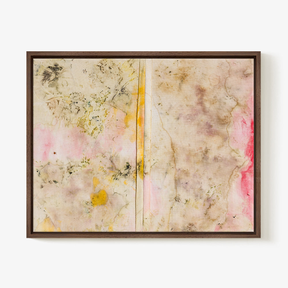 Textile wall art with beige pink and yellow blotchy pigments and a central vertical seam in a dark wood frame