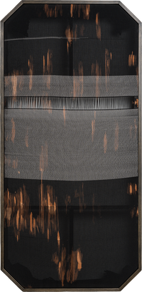Framed vertical fiber art with a black background a central horizontal gray band and copper vertical thread accents