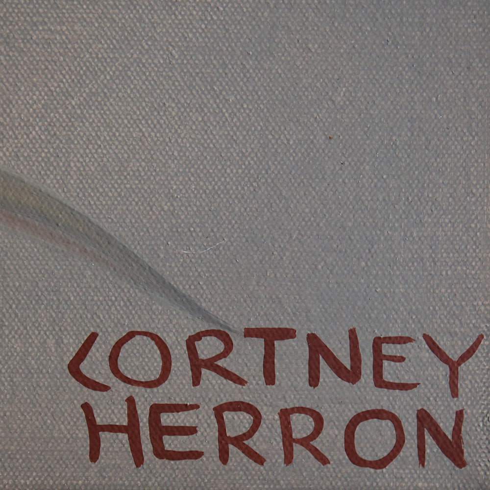 Close-up detail of a gray painted canvas showing the artist signature Cortney Herron in dark red